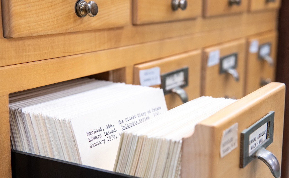 a library card catalogue drawer with white index cards