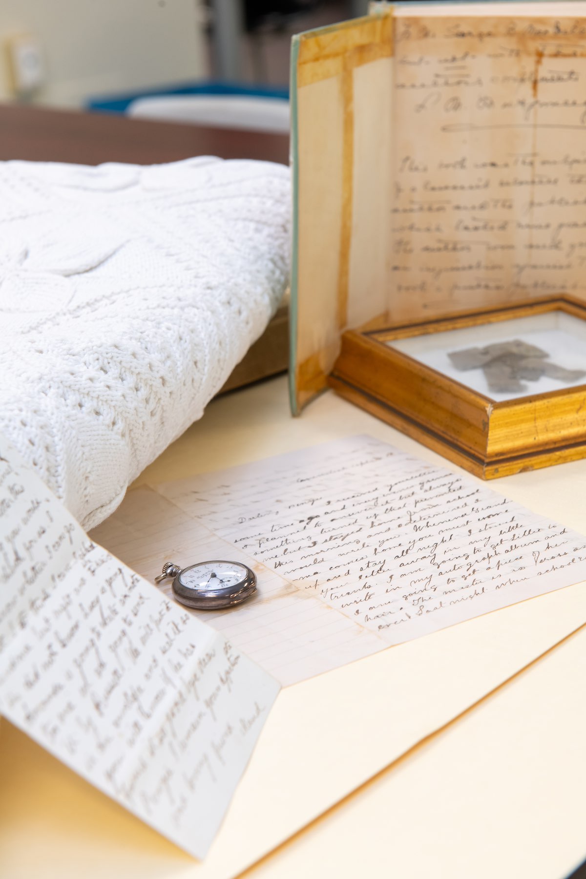 a blanket, pocket watch, and letters owned by Lucy Maud Montgomery